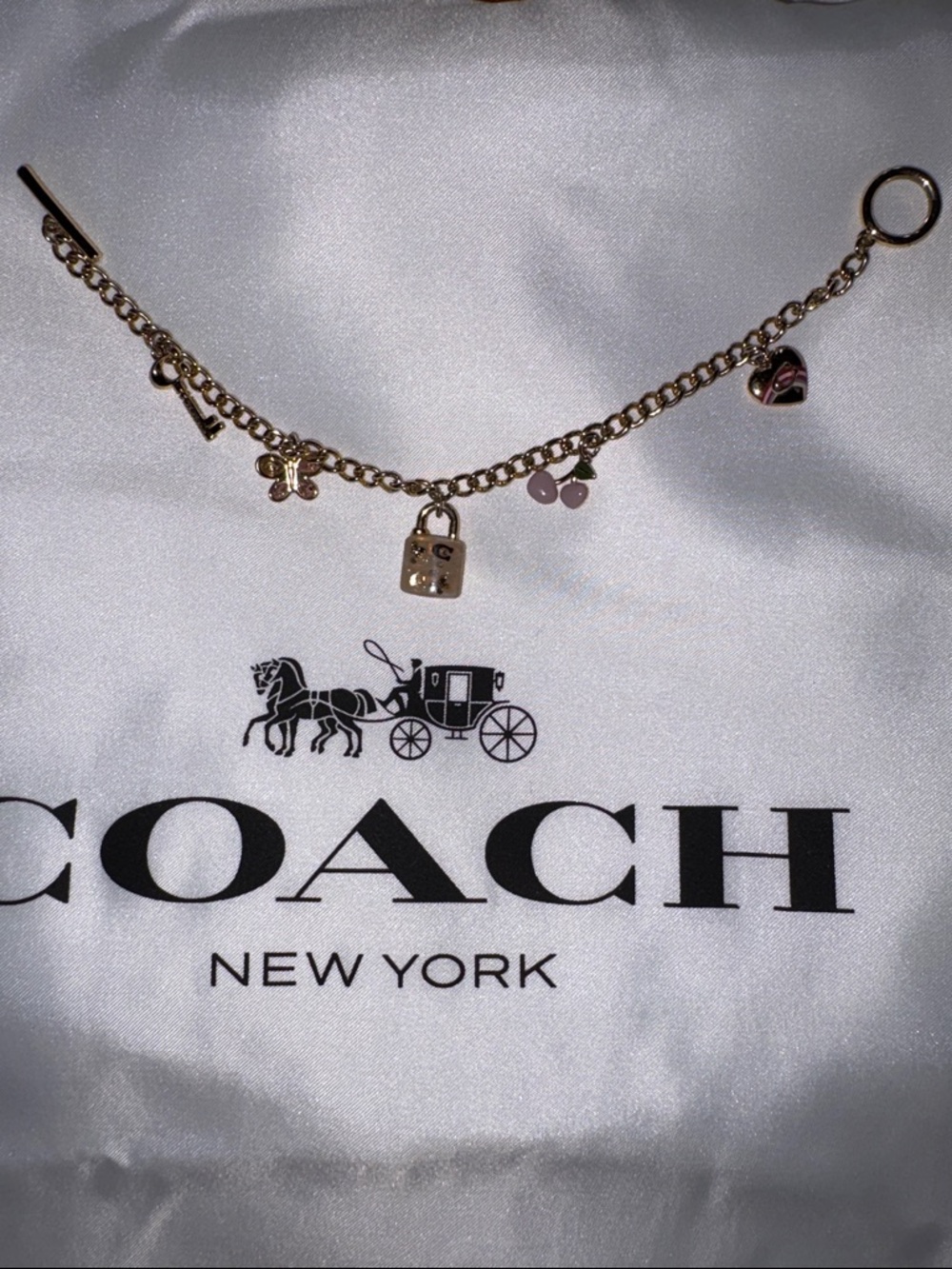 Coach Gold Tone Charm Bracelet with Pink Enamel Accents